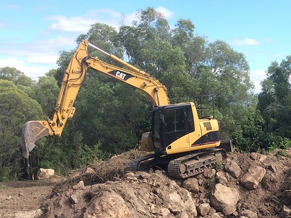 The Cat 311cu has spent a lot of time on rock work.