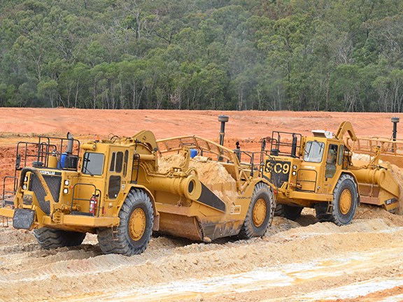 Cat 637 D and E model scrapers working in tandem.