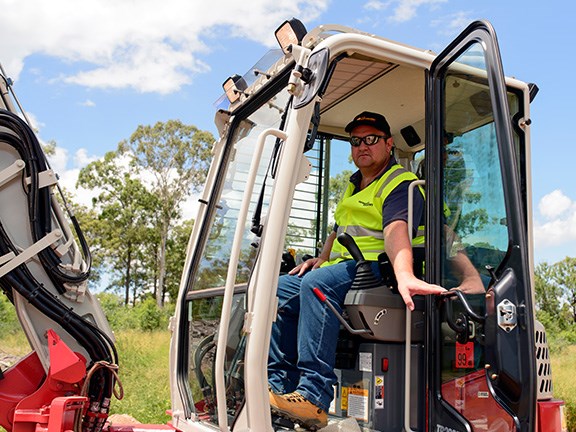 Reviewer Evarn Covich in the cab of the the Takeuchi TB280FR excavator.