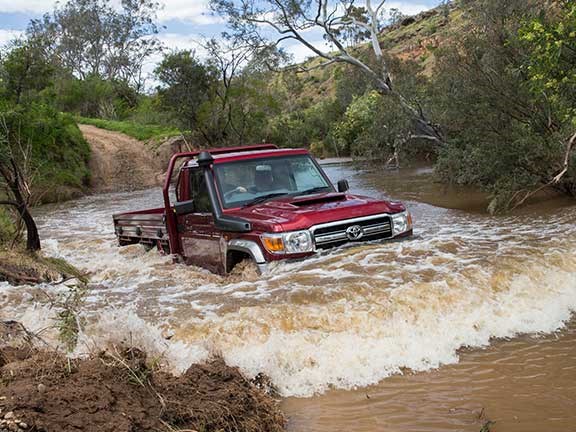Toyota Landcruiser 70 series traversing a river