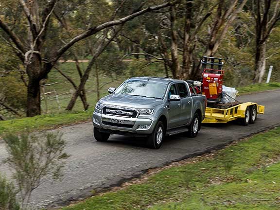 Ford Ranger ute towing excavator