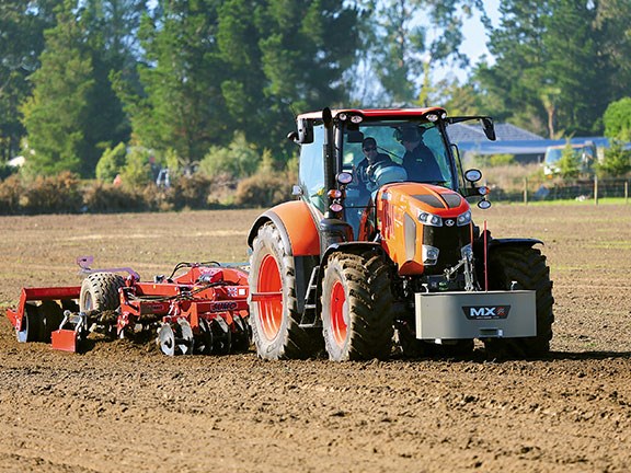 The Kubota M7-171 Premium KVT tractor pulling a 3.5 Sumo Trio cultivator