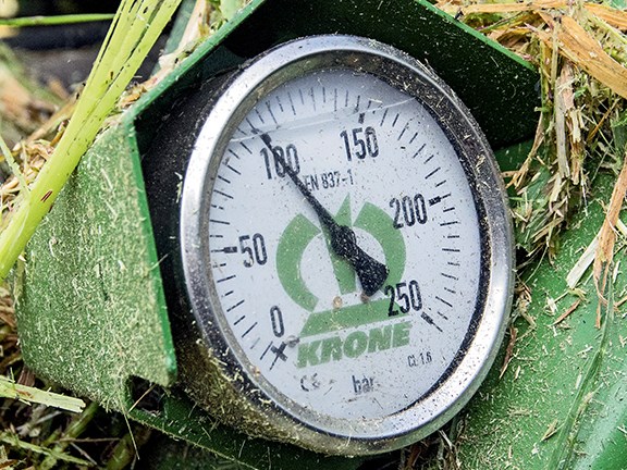 A pressure gauge clearly shows the degree of downward pressure on the mowers.