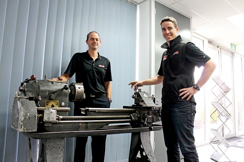 Tim Harrop and Heath Moore show off one of the company's original lathes
