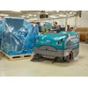 The Tennant S30 Mid-Size Rider Sweeper in use inside.
