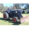 A classic Fordson tractor fitted with a dozer blade.
