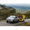 Mitsubishi Triton ute hauling excavator uphill
