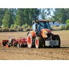 The Kubota M7-171 Premium KVT tractor pulling a 3.5 Sumo Trio cultivator