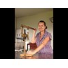 Karen bottling with a handmade bottling press.