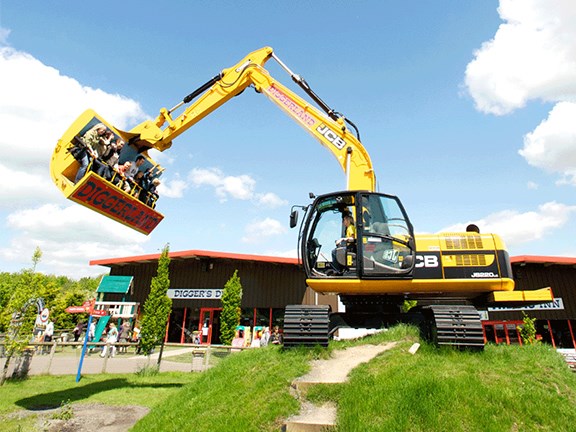 Don't try this at home: Patrons get a ride in the 'bucket' of a JCB JS220 LC excavator at a Diggerland park in the UK.