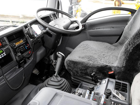 driver's seat and steering wheel in the Isuzu FXZ330 tipper truck