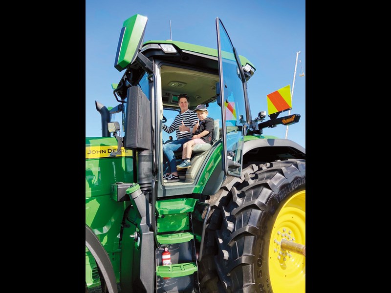 Amy and Ritchie Cudby try the massive John Deere 7R for size