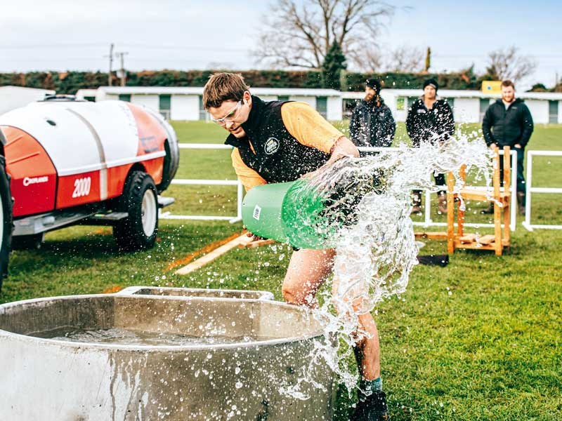 Joseph Watts empties a water trough during the agri sports challenge FMG Young Farmer of the Year