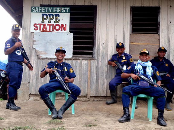 A few of the Filipino guards with shotguns in hand