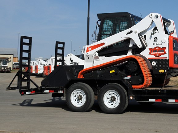 Once on the trailer, compact loader operators should lower the attachment to the floor of the trailer, stop the engine and engage the parking brake.