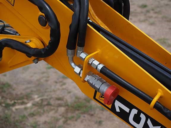 Close up shot of JCB 1CXT backhoe loaders hydraulic and auxilliary lines