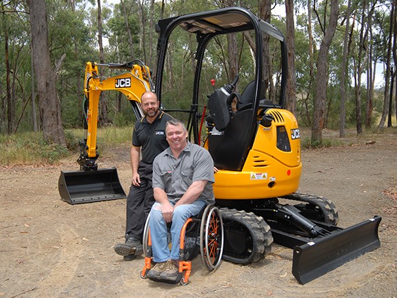 JCB’s Brendan Clarke and safety speaker James Wood with the modified 8025 ZTS mini excavator.