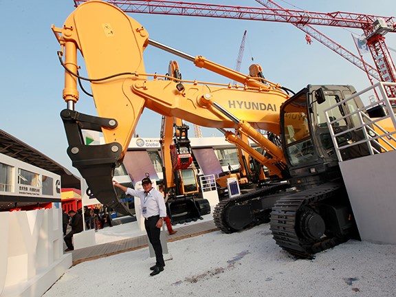 Bauma China 2014: Ron Horner checks out a newly designed ripper and rock dipper arm from Hyundai.