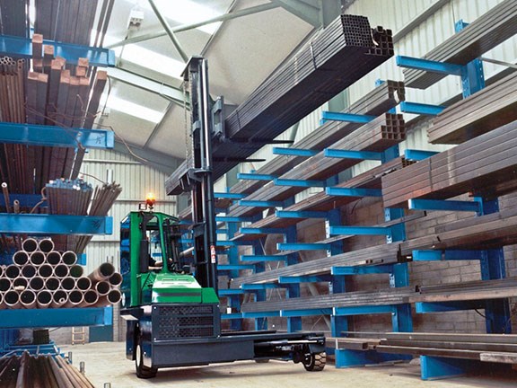 The Combilift C4000 multidirectional forklift shifting steel.