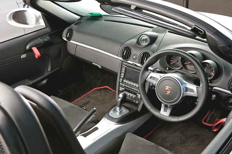 Spyder cabin gets RS-type door straps, no door bins, fixed-back seats