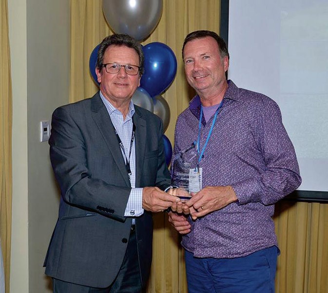 Volvo Club of NSW President Ted Warner (left) presents Ashley Yelds with the Unique Cars trophy