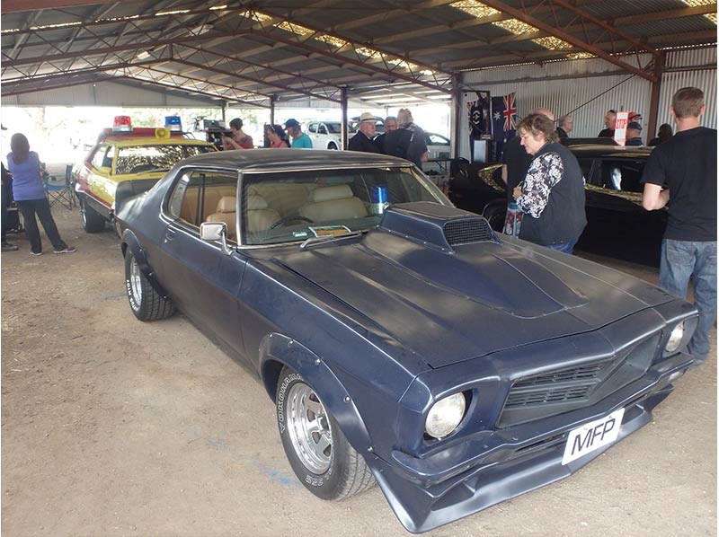 Max’s Falcon hardtop has been replicated – word is, there are 25 around these days, including several in the hands of US-based enthusiasts – but apparently it’s only recently the Holden Monaro based Pursuit Special seen in the opening chase scenes of Mad Max has been replicated. The distinctive bonnet scoop, the missing driver’s side headlight surround, the zoomy exhausts and the boot spoiler  – even the tan trim – has all been faithfully replicated in this. The only thing missing – quite understandably! – is the stoved-in driver’s door and rear quarter panel…       