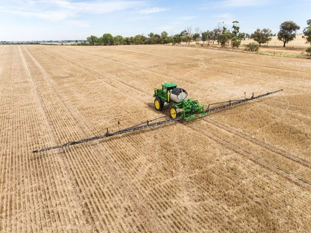 John Deere self-propelled sprayer working in a field