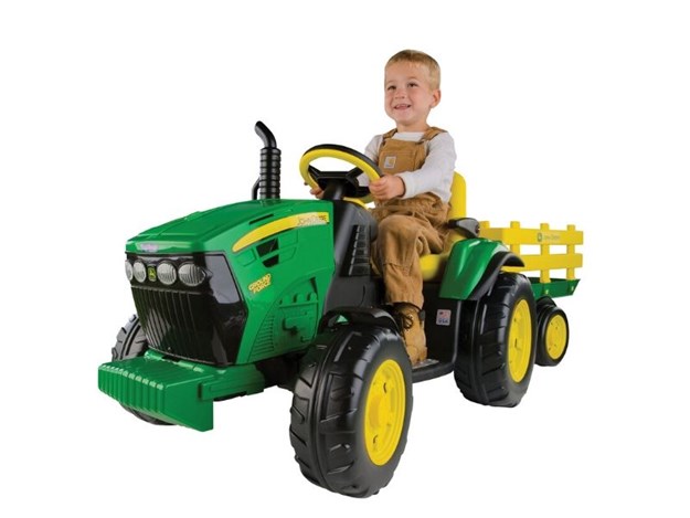 The JOHN DEERE 12V GROUND FORCE TRACTOR AND STAKE WAGON
