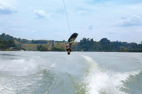 Wakeboarder behind Nautique boat