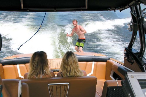 Wake surfer behind Nautique wakeboat