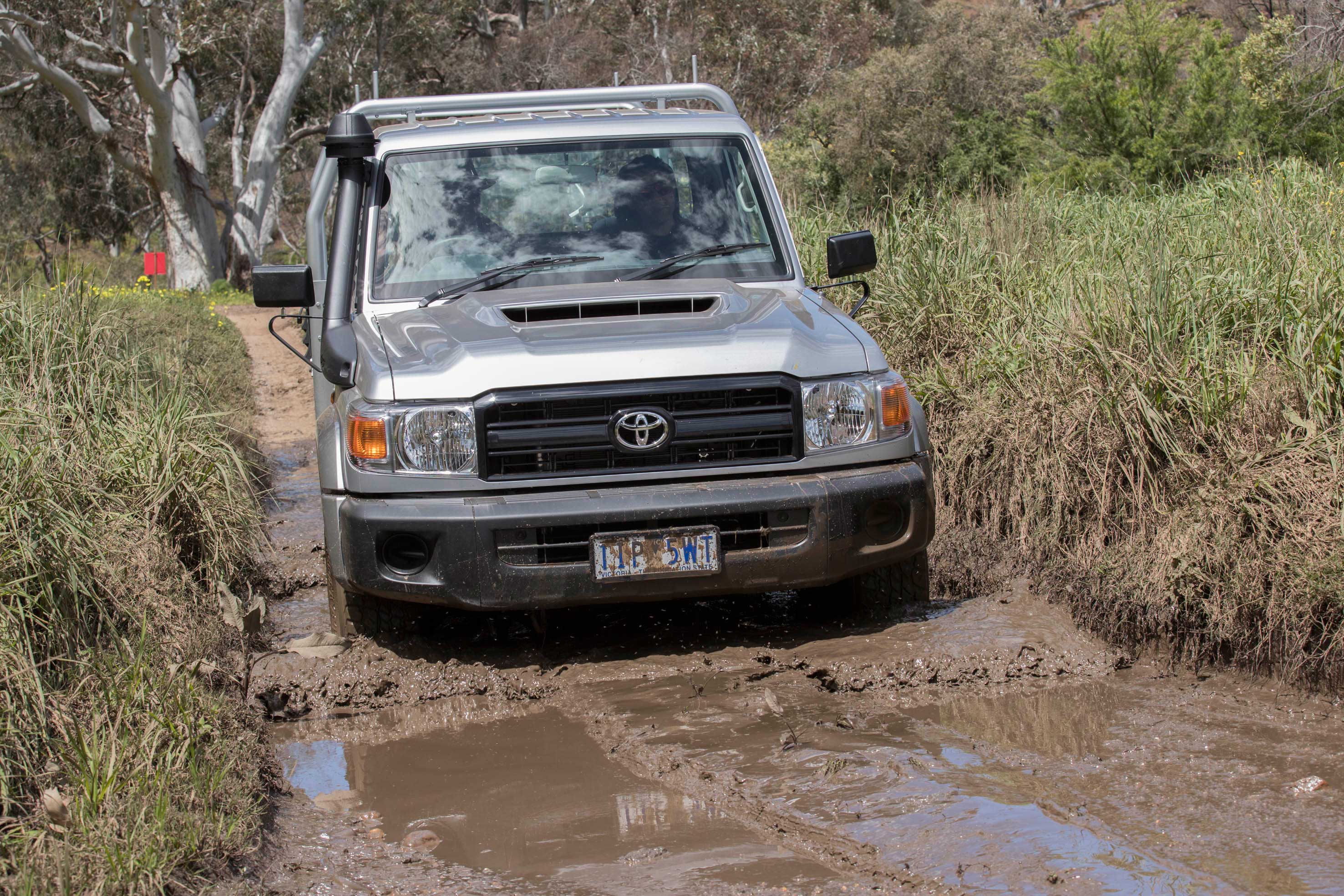Toyota Landcruiser 70 series wading through mud