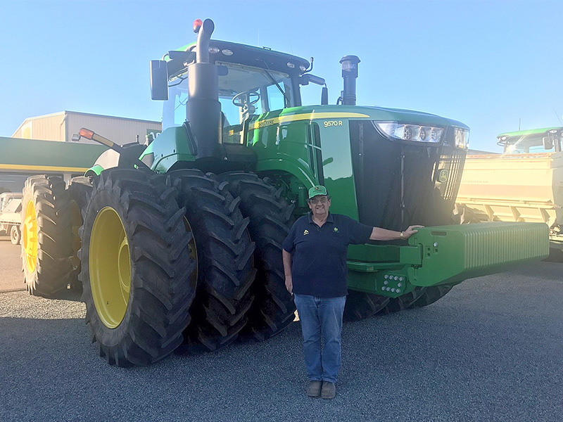 John Nicoletti in front of a John Deere tractor