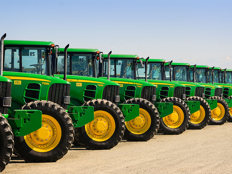Tractors line up in a show for sale