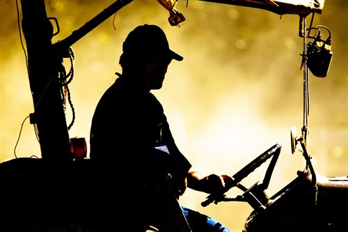 Operator Driving Tractor